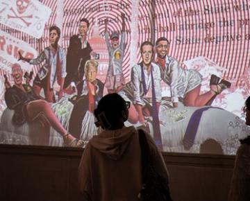 Students watch a projected art display