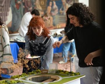 Students interacting with an architecture scale model