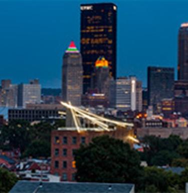 Exterior of Mattress Factory and Pittsburgh city skyline at night