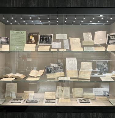 A display case of "We Humans at 70" in Hillman Library